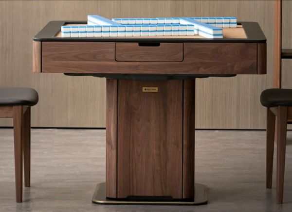 Front view of a black walnut automatic mahjong table with mahjong tiles on the leather top