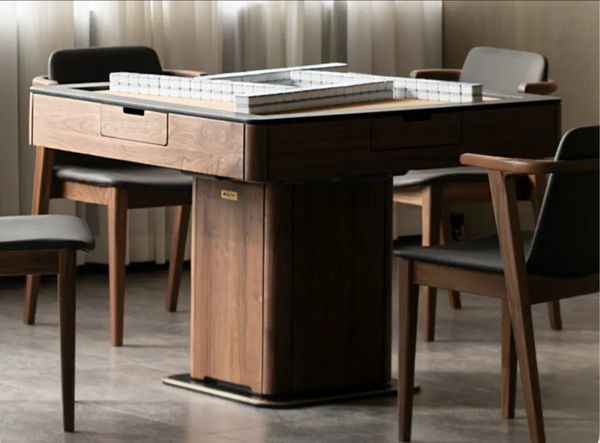 Black walnut automatic mahjong table with leather top and pedestal base in a game room with chairs